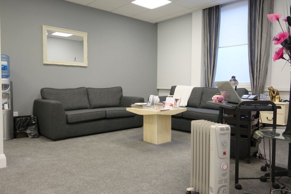 The waiting area at Nature’s Way, with sofas and a low table.